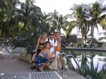 Three reasons why you should quit your job, buy a boat, and sail to Mexico like Greg did.  Kristi, Jean and Cherie surround him by the pool at Paradise Village, Puerta Vallarta, Mexico.