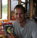 Greg reading the Lonely Planet "Costa Rica" guidebook.