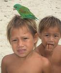 Two Kuna kids and their pet bird.