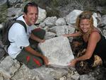 Cherie and Greg with rocks written on by 19th century ship-wrecked sailors.