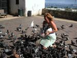 Cherie feeds the pigeons in the park.  *Photo by Stan.