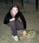 Kristi plays with the cuddly serval.  It may look like a cat, but it doesn't feel like one.