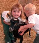 Ellie and Tanner give the goat a hug-ball.