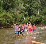 We had to use bamboo rafts to get from one village to the next while trekking in the hill-tribes. *Photo by Yorham.