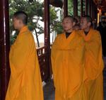 Preparing for the service, the monks enter in a parade of saffron.