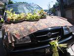 A car covered with offerings for Shiva.