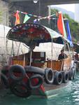The sampans are charming little boats that resemble tiny tug boats--they have more tires than a truck!