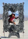 Cherie in a frame in the middle of Black Rock Desert at the Burning Man Festival 2005. *Photo by Greg.