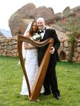Kevin and Clara wed on October 21, 2005 in Red Rocks Park, Denver, Colorado.  True love is posing with your wife and a harp.