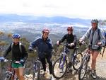 Hannah, Cherie and Elizabeth bike down Mt. Wellington.