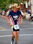 Crossing the finish line in a cowboy hat.