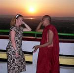 Cherie talking to a monk at sunset on Mandalay Hill. *Photo by Jean Leitner.