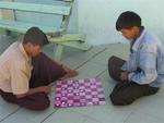 Myanmar men playing checkers.