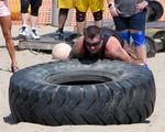 Strategy: Get a hold of the tire, dig into the sand, and flip.