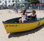 Girls chillin' in a beached boat.