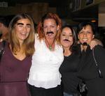 Four ladies eagerly darn mustaches, bushy eyebrows and goatees at the Mushtache Party held at the Costa Mesa restaurant called "Memphis."