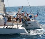 The crew of Seawings gives a hearty wave. *Photo by Richard/Latitude 38.
