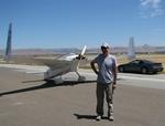 Greg next to his plane and his car. (The plane gets better gas mileage!)