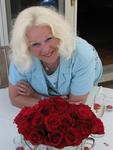 Mom with her vibrant red roses.