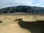 A dune with an "alluvial fan" (that's just a fancy way of saying "gathering of debris.")