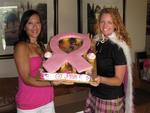 Tonya and Cherie hold the pink ribbon cupcakes from Val and Jeff.